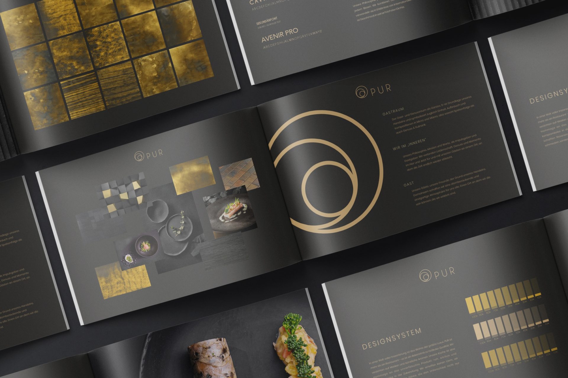 Aufgeschlagenes Markenbuch aus der Markenarbeit von TasteWorks: Logo, Typografie und Farbsystem in Gold auf dunklem Papier