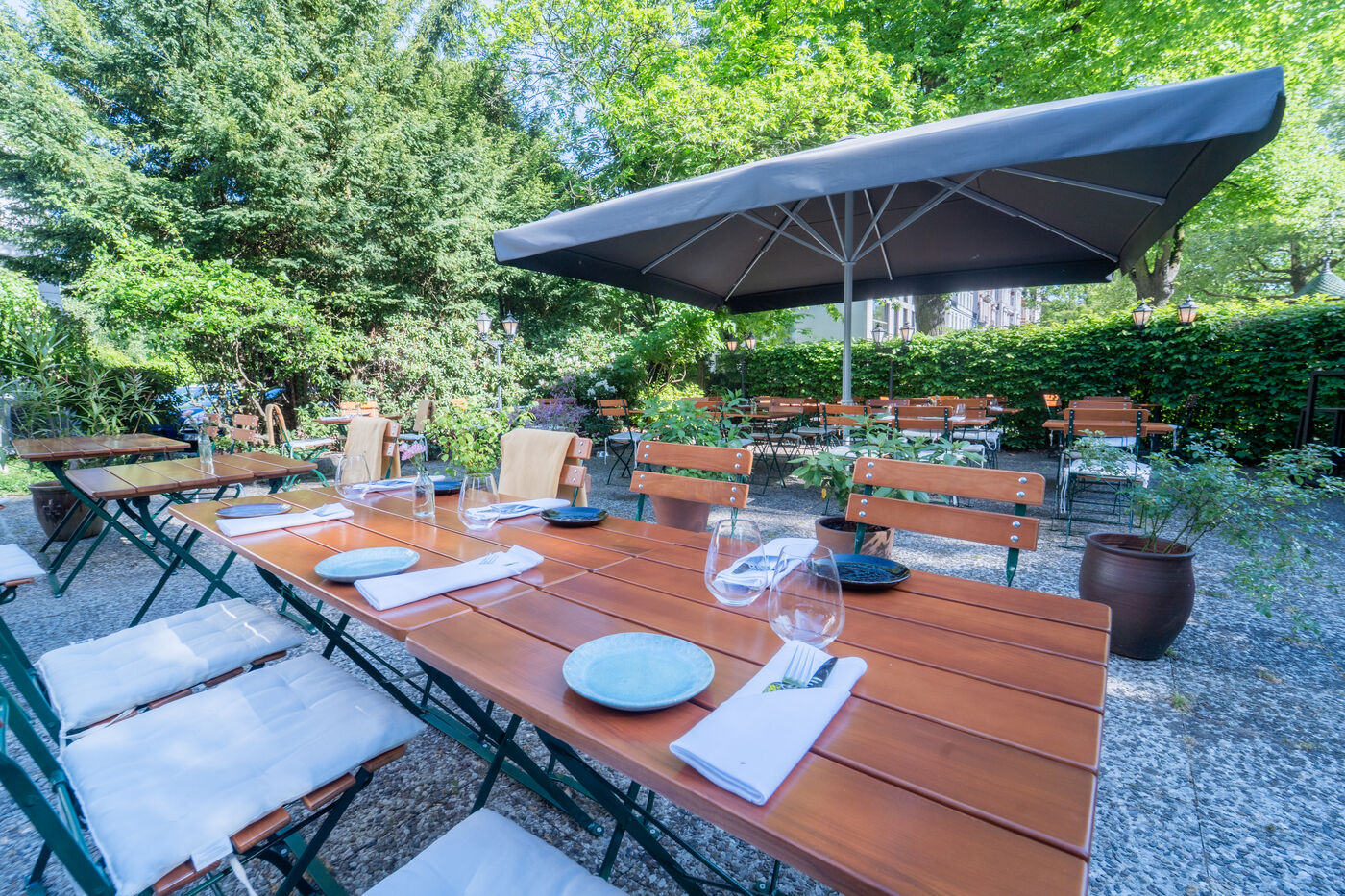 Gedeckte Sommerterrasse unter Sonnenschirmen im Grünen, Restaurant Brodersen, Hamburg